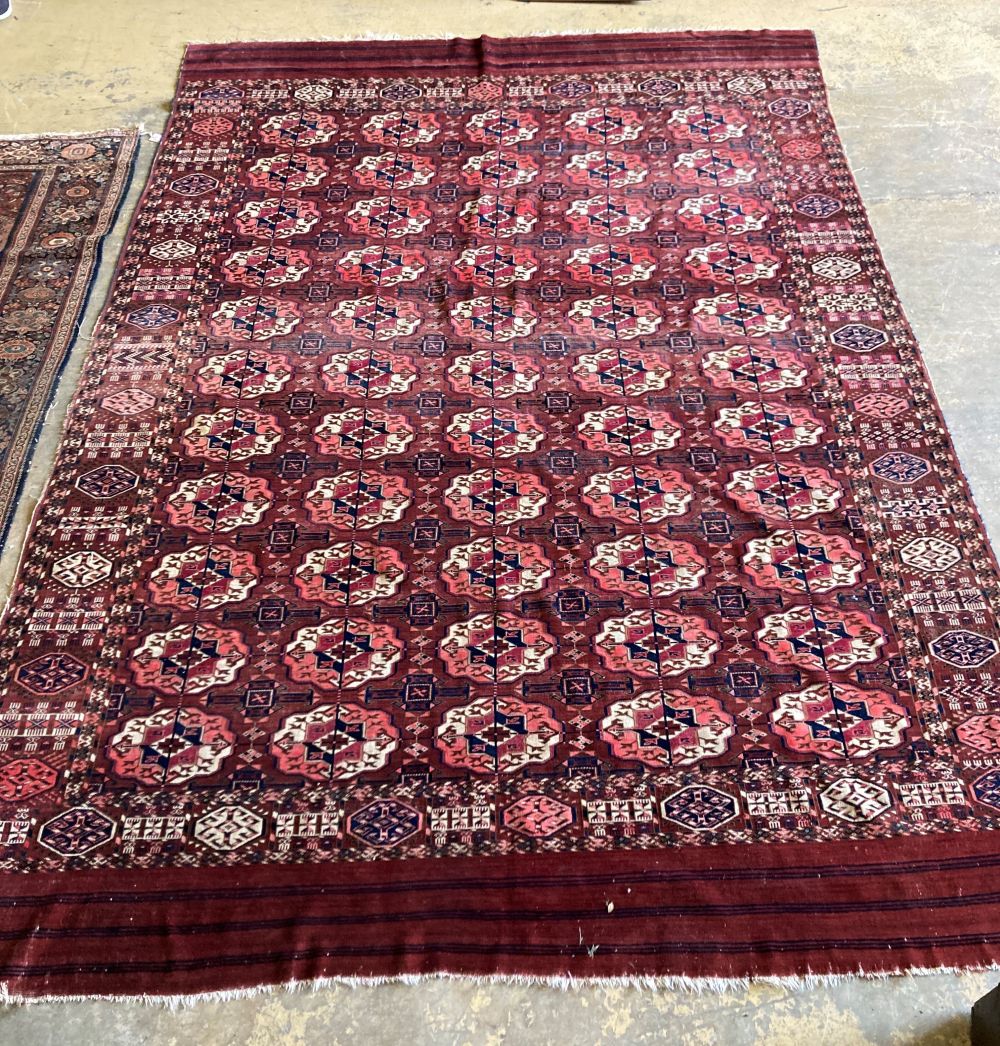 A Tekke Bokhara rug, red ground with lines of five guls, 280 x 200cm